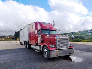 Red Semi Truck Parked on Side of Road