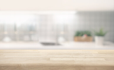 Selective focus.Wood table counter island on blur kitchen wall background.