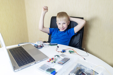 Programming for children. The boy is studying online at a robotics school for programming courses. Child learning control board coding