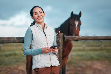 Portrait, phone and woman at horse farm outdoor for social media, internet or jockey laughing at...