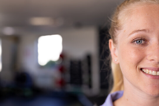 Caucasian female physical therapist, wearing purple top, treating patient at gym rehabilitation cent