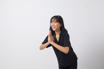 Portrait of attractive Asian woman in casual shirt showing apologize and welcome hand gesture. Businesswoman concept. Isolated image on white background