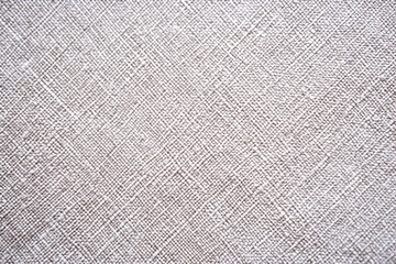 Fototapeta premium Close-up of a textured fabric pattern with intricate crosshatch lines creating a subtle and sophisticated design