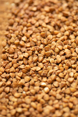Buckwheat grain. Buckwheat texture. Macro photograph of buckwheat. Healthy eating background.