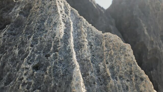 Grey karst limestone cliffs with steep furrowed slopes. Close-up. Tsingy De Bemaraha, Madagascar (4K)