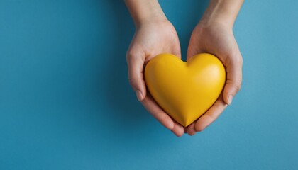 Cupped hands holding a yellow heart, minimal, blue background