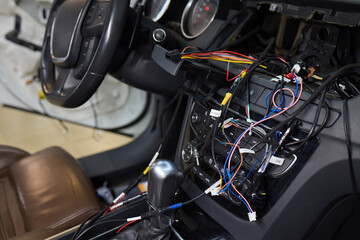Individual is performing maintenance on the vehicles dashboard