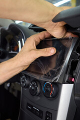 Individual is performing maintenance on the vehicles dashboard