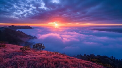 A vibrant sunrise illuminates the mountain, casting a warm glow over the misty valley and serene landscape.
