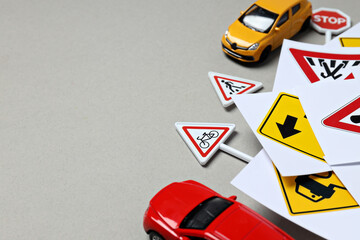 Traffic signs and vehicles on a light background.