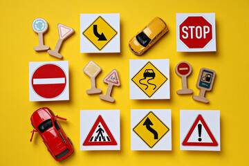 Road signs and vehicles on a yellow background.