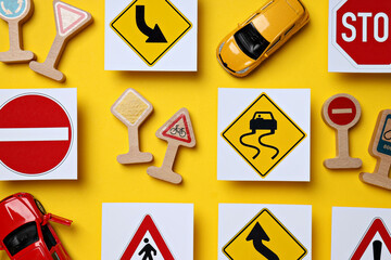 Road signs and vehicles on a yellow background.