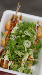 Small container of food with chopsticks