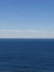 Distant boats on calm blue sea