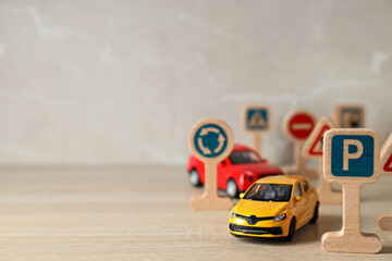 Traffic signs and vehicles on a light background.