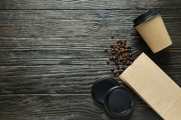 Craft coffee cups with coffee beans on a dark background