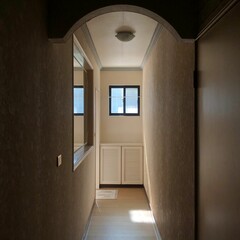 a doorway way leading into a room with a small window