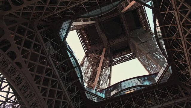 Video taken under the Eiffel Tower at sunset, offering a unique perspective of its intricate steel structure