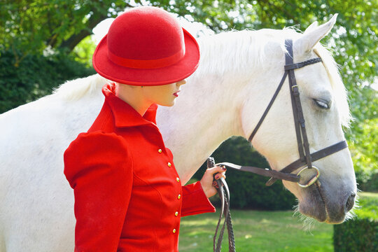 Woman in Red Equestrian Outfit with Horse
