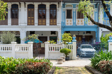 Car parked in front of the white and blue building