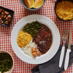 Feijoada dish with rice, farofa, cabbage and crackling