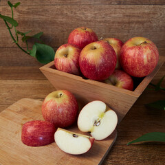 Whole and cut apples in a wooden box
