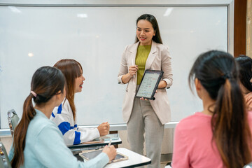 A woman is teaching a group of students