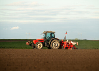 Obraz premium Tractor and seeder for sowing corn