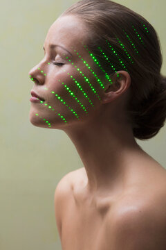 Beauty Portrait of Woman with Laser beam on Face
