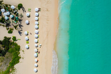 Caribbean Serenity: A Bird's-Eye View of Paradise, turquoise water, white sand and beach umbrellas.