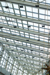 A starshaped light fixture suspended from the ceiling of a commercial building