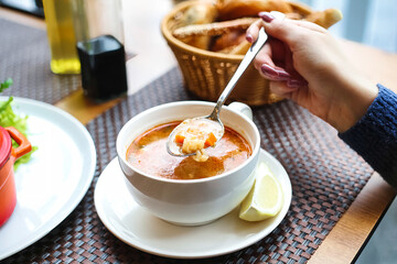 Bowl of Tomato Soup With a Silver Spoon