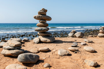 Composition of stones balanced on the beach. Front view. Horizontal image. Copy space
