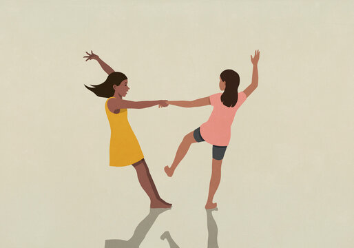 Carefree, barefoot girl friends holding hands and dancing on beige background
