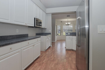 Modern white kitchen with elegant wood floors