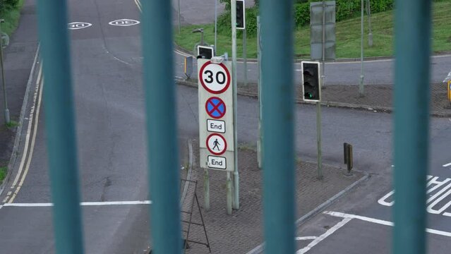 30 Miles Per Hour Sign on Dual Carriageway with Truck Passing in Early Morning with Traffic Lights in Wales UK