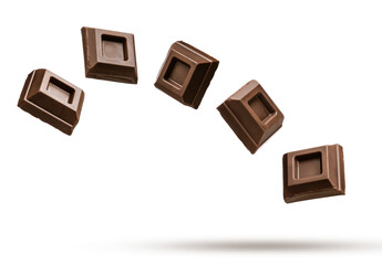 Dark chocolate blocks flying on white background.