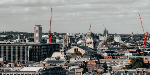 City skyline with construction in progress, cranes and buildings, London, UK