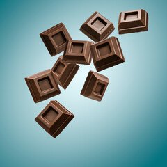 Dark chocolate blocks flying on blue background.