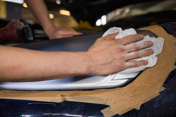 Person using a machine to polish automotive lighting on a car headlight