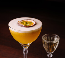 Elegant passion fruit cocktail with shot glass