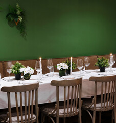 Elegant dining table setup with green background