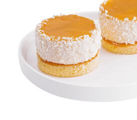 Coconut mango cakes on white plate