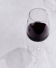 Elegant glass of red wine on marble surface