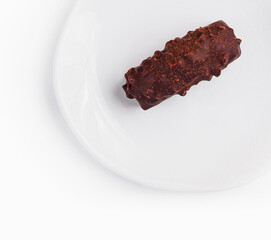 Single chocolate bar on white plate