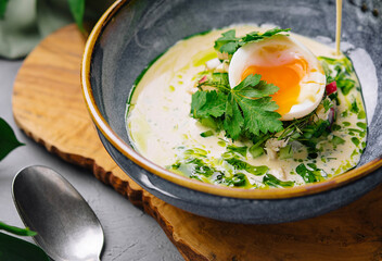 Gourmet poached egg breakfast bowl with hollandaise sauce