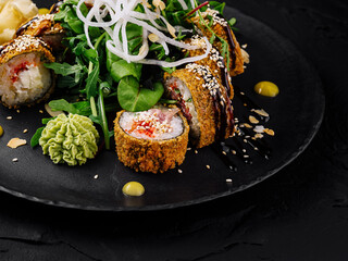 Gourmet sushi roll on dark slate plate