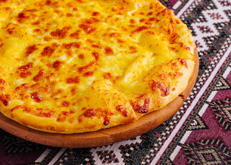 Delicious cheese pizza on traditional tablecloth