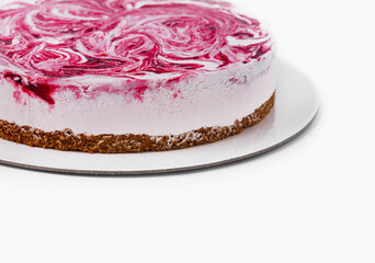 Fresh homemade raspberry swirl cheesecake on white