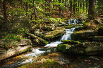 Waterfall on Hucava stream in forest of natural parkland Jeseniky mountains, Czech Republic. Beautiful tranquil scenery in nature